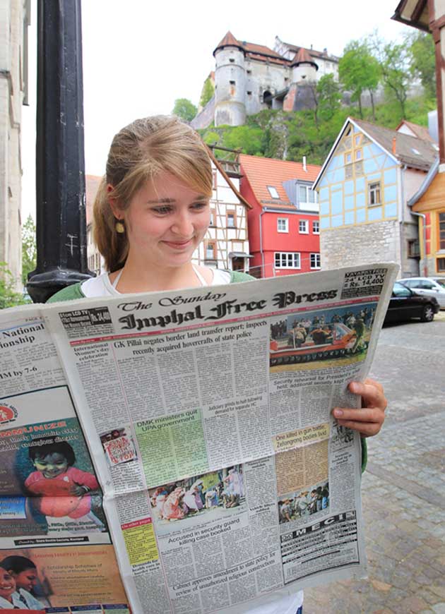 IMPHAL FREE PRESS, March 6, 2011, issue being read in the German town of Heidenheim. This is part of a public art project by some academics in England and Ireland with the objective of connecting different outlying provinces of the world through the provincial media. IMPHAL FREE PRESS coordianted with HEIDENHEIMER ZEITUNG in Germany and had on March 6 carried a photo feature titled "Where is Imphal?". This particular page was also reproduced in the HEIDENHEIMER ZEITUNG and circulated.