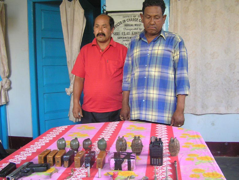 The two RPF/PLA cadres arrested by Imphal West police commandos being paraded before mediapersons along with the recovered arms at the CDO complex.