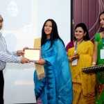 Dr Mridul Hazarika felicitating award to Ms Binalakshm Nepram