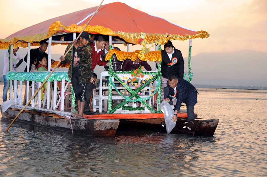 CEO of Chanura Microfin releasing hatchlings of fishes at Loktak Lake in observation of 8th Foundation Day of Chanura Microfin.
