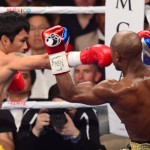 Floyd Mayweather, right, defends against Manny Pacquiao during their welterweight unification bout