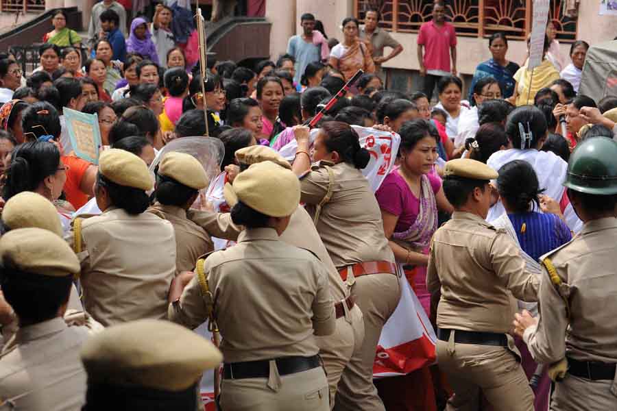 Police women trying to control vendors of Ima Keithels during a protest rally.