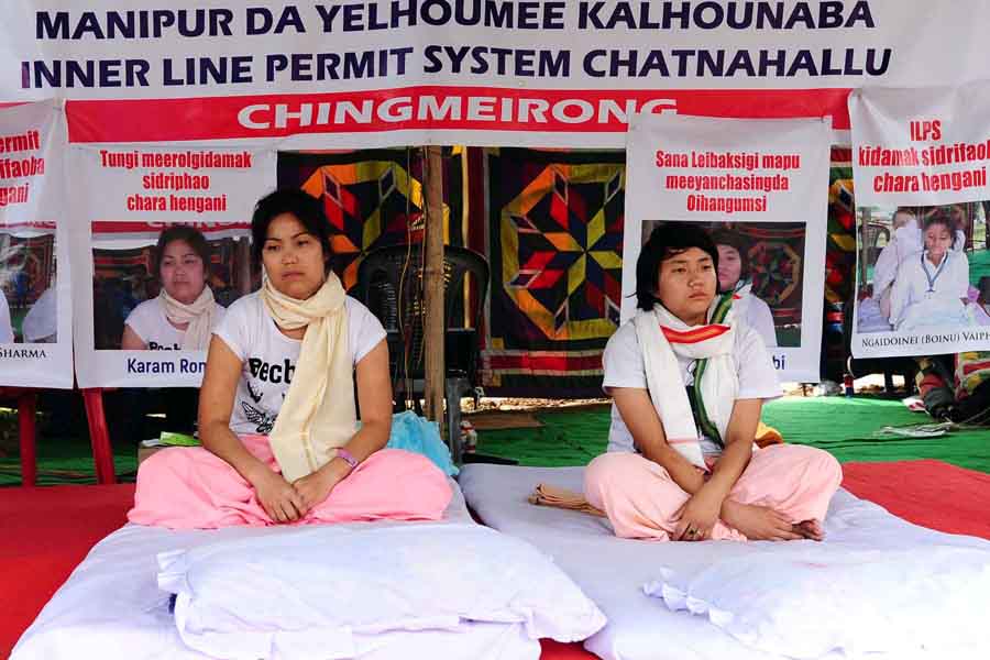 A young girl joins a woman on hunger strike at Chingmeirong