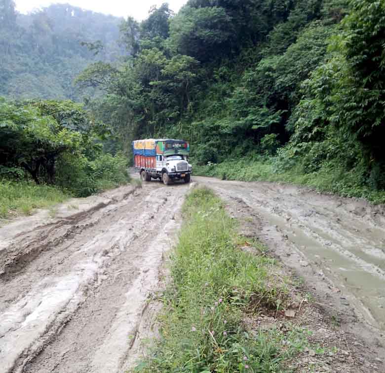 A truck trying to manoeuvre through the muddy Imp-Jiribam Highway stretch at Makru.