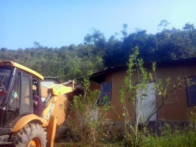 A bull dozer being used to tear down an encroachment inside the Heingang Reserved Forest area on Saturday.