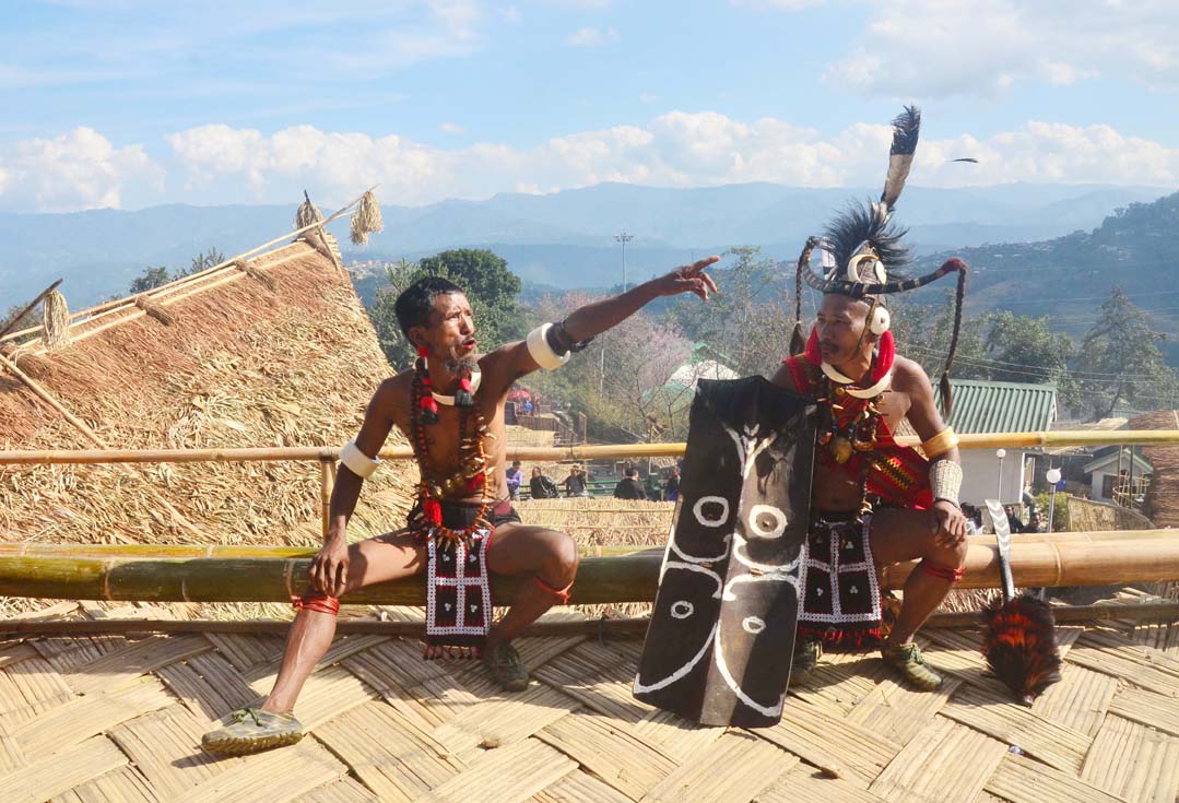 Naga tribesman gesture as they rest after their performance in front of their Morung on the second day of the state annual Hornbill Festival at Naga Heritage village Kisama, some 15 kms away from Kohima, Nagaland on Friday, December 02, 2016. Photo by Caisii Mao